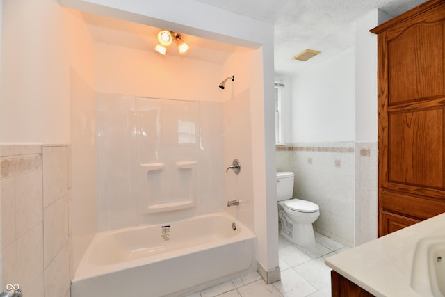 1346 W 27th St, Indianapolis, IN 46208 - full bath featuring tile walls, toilet, vanity, tile patterned flooring, and  shower combination