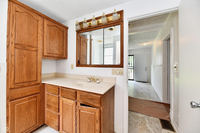 1346 W 27th St, Indianapolis, IN 46208 - kitchen featuring a sink, light countertops, and brown cabinets