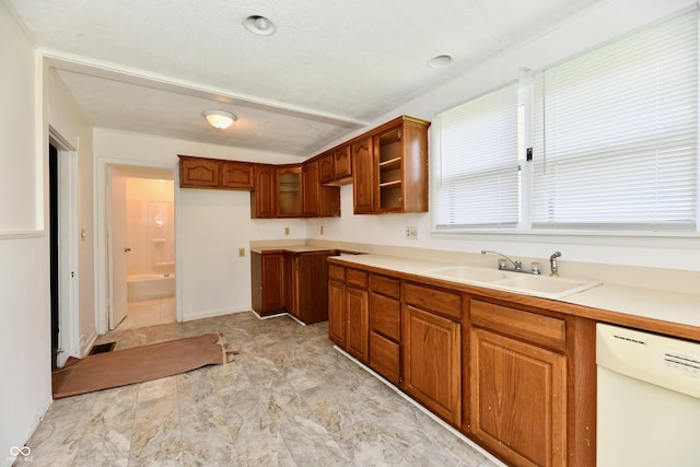 1346 W 27th St, Indianapolis, IN 46208 - kitchen featuring dishwasher, a sink, brown cabinetry, and light countertops