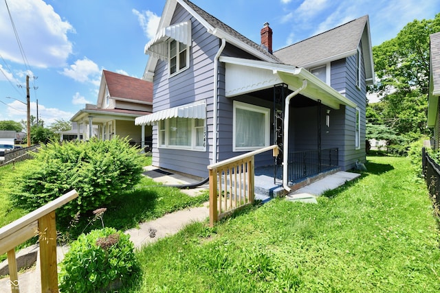 1346 W 27th St, Indianapolis, IN 46208 - view of side of home with a chimney