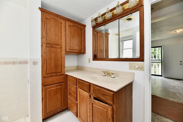 1346 W 27th St, Indianapolis, IN 46208 - kitchen with brown cabinets, light countertops, a sink, and light tile patterned floors