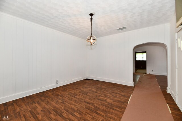 1346 W 27th St, Indianapolis, IN 46208 - empty room featuring arched walkways, dark wood-style floors, and baseboards
