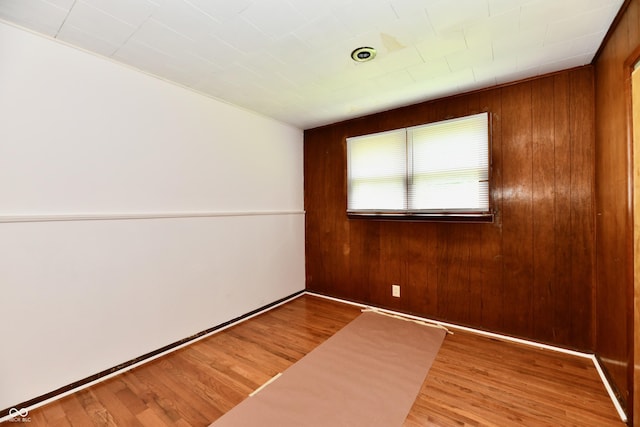 1346 W 27th St, Indianapolis, IN 46208 - spare room featuring wood walls and wood finished floors