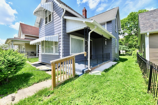 1346 W 27th St, Indianapolis, IN 46208 - view of home's exterior featuring a chimney