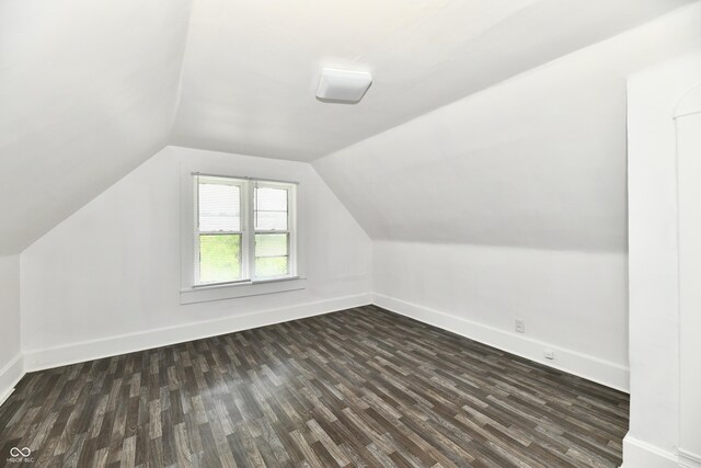 1346 W 27th St, Indianapolis, IN 46208 - additional living space with dark wood-style flooring, vaulted ceiling, and baseboards