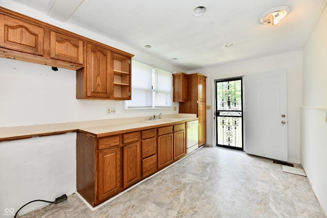 1346 W 27th St, Indianapolis, IN 46208 - kitchen with dishwasher, brown cabinetry, a sink, and light countertops
