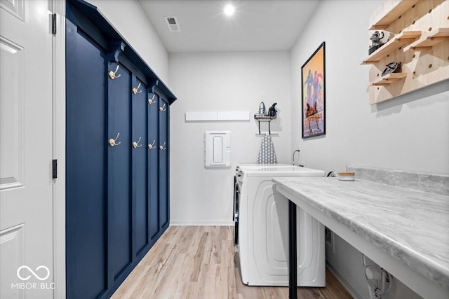 7154 Covington St, Lebanon, IN 46052 - laundry room featuring washing machine and dryer, light wood-style floors, and baseboards