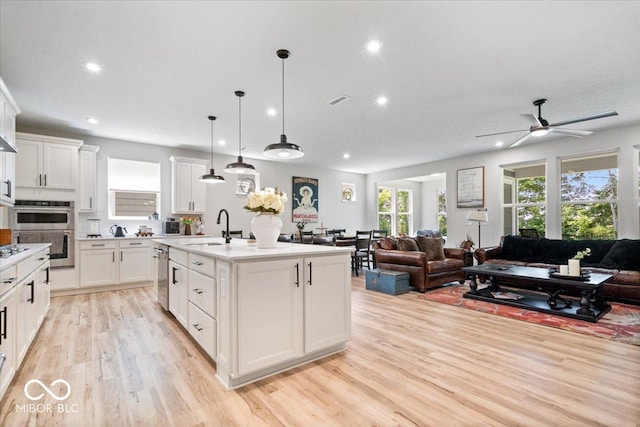 7154 Covington St, Lebanon, IN 46052 - kitchen featuring open floor plan, a sink, recessed lighting, light wood-style flooring, and white cabinetry