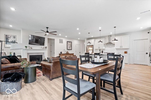 7154 Covington St, Lebanon, IN 46052 - dining space with ceiling fan, light wood-style floors, recessed lighting, and a glass covered fireplace