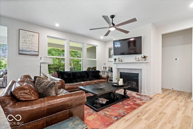 7154 Covington St, Lebanon, IN 46052 - living room with a ceiling fan, wood finished floors, a glass covered fireplace, recessed lighting, and baseboards