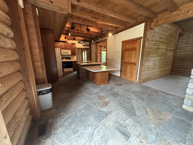 2858 N Stout Rd, Liberty, IN 47353 - kitchen featuring wood ceiling with exposed beams, white appliances, stone flooring, light countertops, and a kitchen island