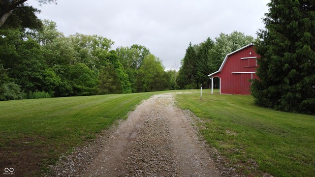 2858 N Stout Rd, Liberty, IN 47353 - view of dirt / gravel road featuring a barn and a forest view