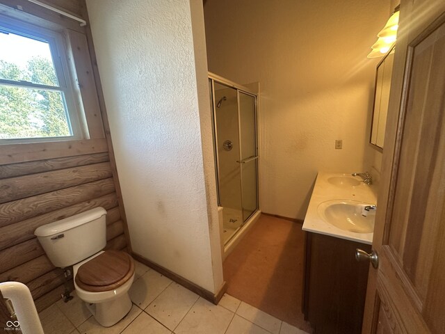 2858 N Stout Rd, Liberty, IN 47353 - full bathroom with log walls, a stall shower, toilet, double vanity, and tile patterned flooring