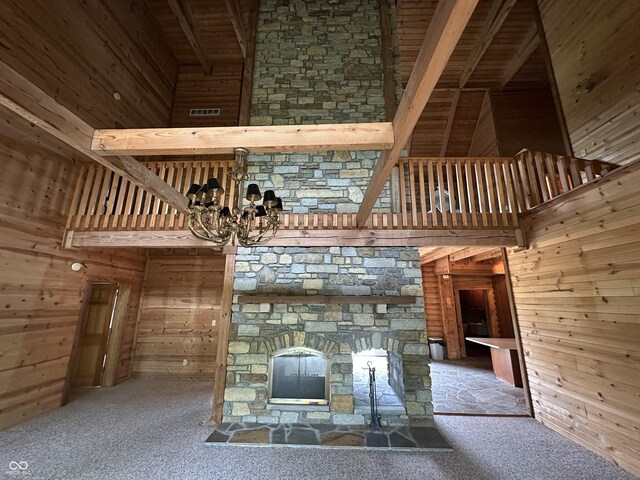 2858 N Stout Rd, Liberty, IN 47353 - detailed view of wooden walls, a stone fireplace, carpet floors, a chandelier, and wood ceiling with exposed beams