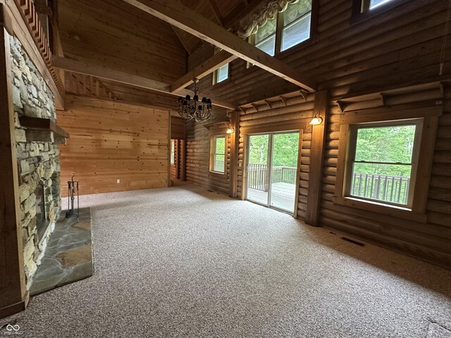 2858 N Stout Rd, Liberty, IN 47353 - unfurnished living room with carpet floors, a towering ceiling, a chandelier, and rustic walls