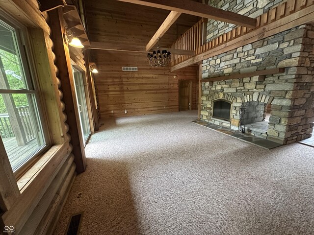 2858 N Stout Rd, Liberty, IN 47353 - unfurnished living room with carpet flooring, a fireplace, a chandelier, wooden ceiling, and wooden walls