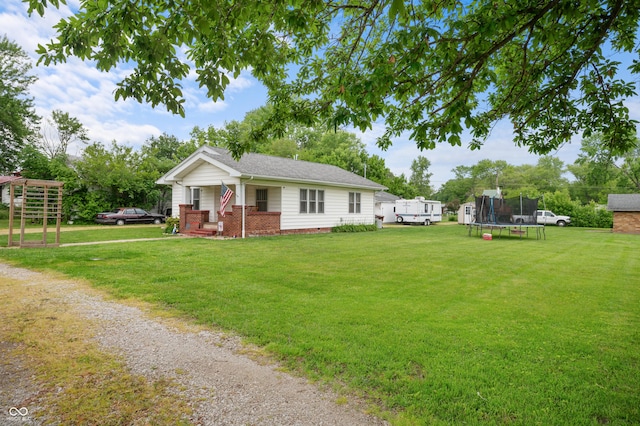11780 S Hoover St, Clinton, IN 47842 - view of front of property featuring a trampoline, a porch, a front lawn, and brick siding