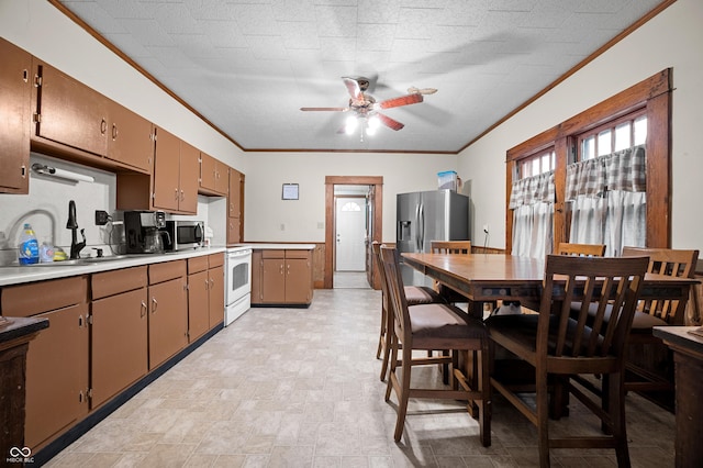 11780 S Hoover St, Clinton, IN 47842 - kitchen featuring ceiling fan, ornamental molding, light countertops, appliances with stainless steel finishes, and a sink