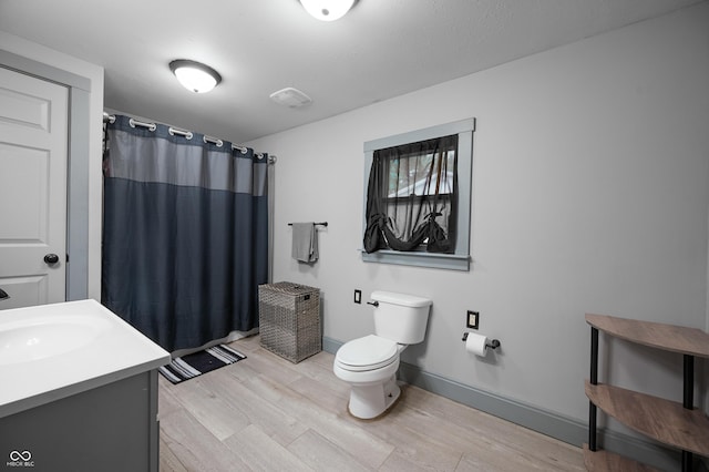 11780 S Hoover St, Clinton, IN 47842 - full bath with toilet, wood finished floors, vanity, and curtained shower