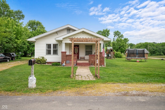 11780 S Hoover St, Clinton, IN 47842 - view of front of property with a trampoline, covered porch, a front yard, a playground, and brick siding