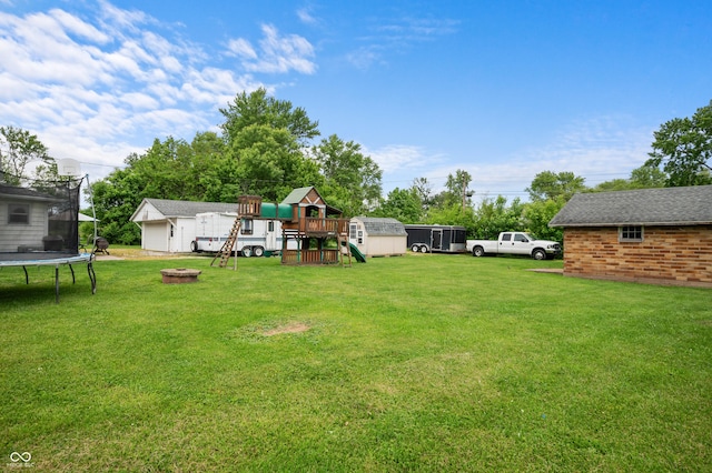 11780 S Hoover St, Clinton, IN 47842 - view of grassy yard with a trampoline, a playground, and a fire pit