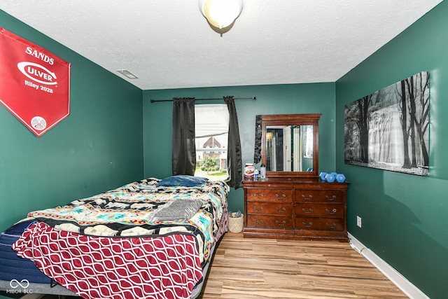 1217 Old Vines Trl, Greenwood, IN 46143 - bedroom featuring wood finished floors and a textured ceiling