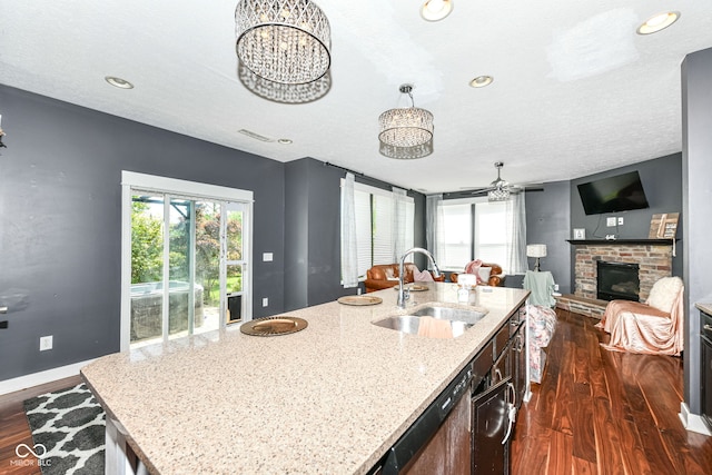 1217 Old Vines Trl, Greenwood, IN 46143 - kitchen with dishwasher, dark wood-type flooring, open floor plan, a brick fireplace, and a ceiling fan