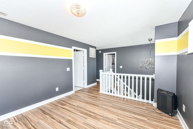1217 Old Vines Trl, Greenwood, IN 46143 - empty room with wood finished floors and a chandelier