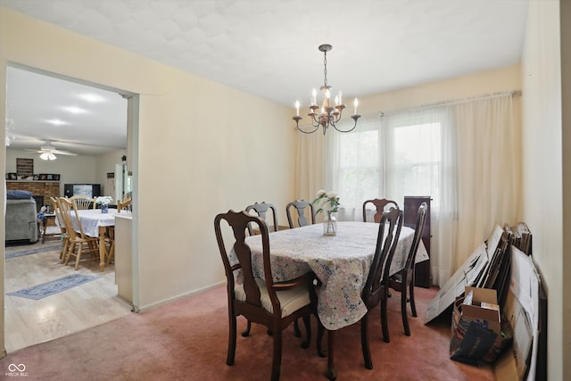 1914 S Avon Ave, Avon, IN 46123 - dining space featuring a chandelier, a ceiling fan, baseboards, and light colored carpet