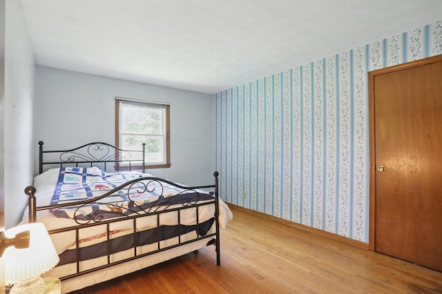1914 S Avon Ave, Avon, IN 46123 - bedroom featuring wood finished floors, wallpapered walls, and baseboards