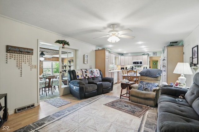 1914 S Avon Ave, Avon, IN 46123 - living room with a ceiling fan, light wood-style flooring, and ornamental molding