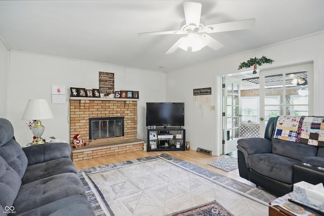1914 S Avon Ave, Avon, IN 46123 - living room featuring wood finished floors, ceiling fan, a brick fireplace, and crown molding