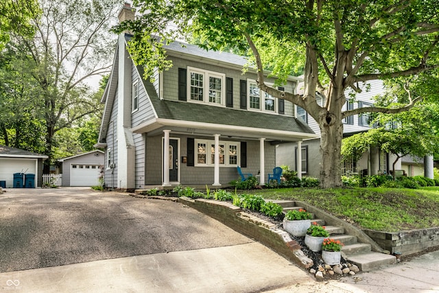 4619 N Park Ave, Indianapolis, IN 46205 - view of front of house with a garage, a porch, a shingled roof, a chimney, and an outbuilding