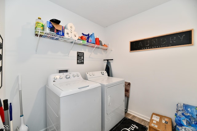 6883 Honeysuckle Way, Pendleton, IN 46064 - laundry room featuring washer and clothes dryer, wood finished floors, and baseboards