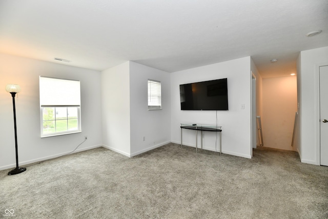 6883 Honeysuckle Way, Pendleton, IN 46064 - unfurnished living room with plenty of natural light, carpet, and baseboards