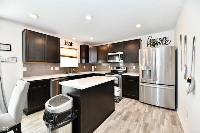 6883 Honeysuckle Way, Pendleton, IN 46064 - kitchen featuring appliances with stainless steel finishes, light countertops, a sink, tasteful backsplash, and recessed lighting