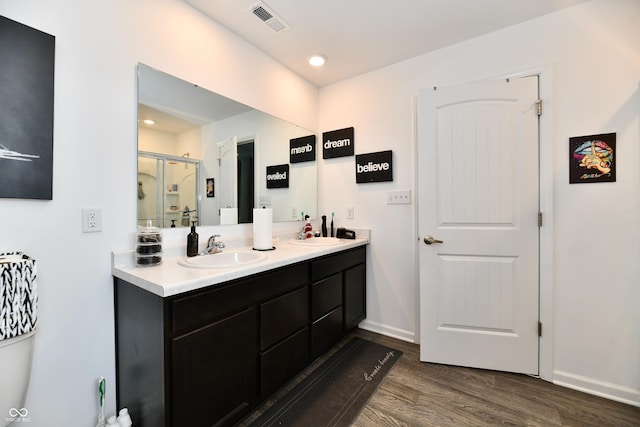 6883 Honeysuckle Way, Pendleton, IN 46064 - bathroom featuring wood finished floors, a shower stall, double vanity, and baseboards