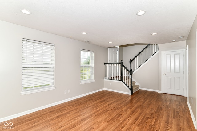 174 Straughn Ln, Westfield, IN 46074 - unfurnished living room with light wood finished floors, baseboards, recessed lighting, and stairway