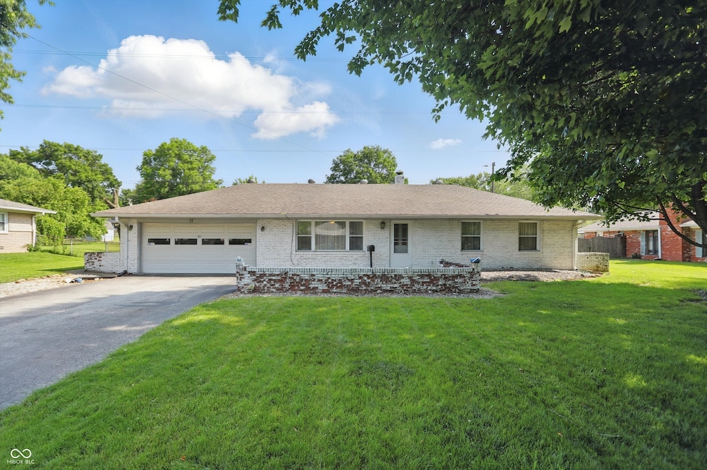 17 E Beechwood Ln, Indianapolis, IN 46227 - ranch-style house with a garage, driveway, brick siding, and a front yard