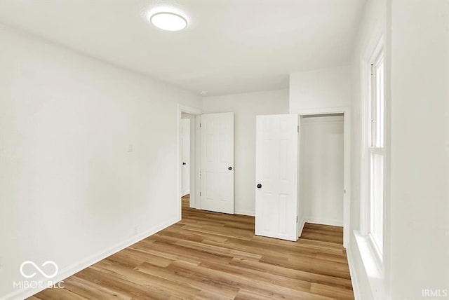 701 E Memorial Dr, Muncie, IN 47302 - unfurnished bedroom with light wood-style flooring and baseboards