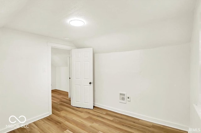 701 E Memorial Dr, Muncie, IN 47302 - additional living space featuring vaulted ceiling, baseboards, and light wood-style flooring
