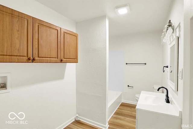 701 E Memorial Dr, Muncie, IN 47302 - full bath featuring vanity, wood finished floors, toilet, and baseboards