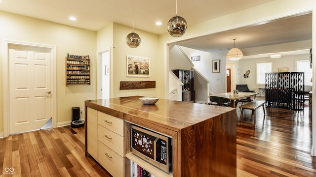 2020 N Park Ave, Indianapolis, IN 46202 - kitchen featuring wood counters, wood-type flooring, stainless steel microwave, hanging light fixtures, and recessed lighting