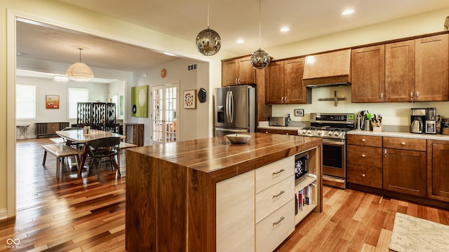 2020 N Park Ave, Indianapolis, IN 46202 - kitchen with appliances with stainless steel finishes, wood counters, custom exhaust hood, light wood-style floors, and recessed lighting