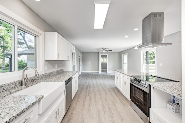496 N County Road 325 W, Danville, IN 46122 - kitchen featuring appliances with stainless steel finishes, island range hood, recessed lighting, white cabinets, and light wood-style floors