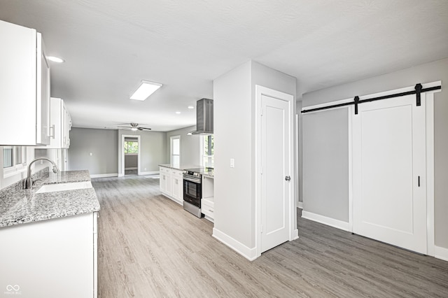 496 N County Road 325 W, Danville, IN 46122 - kitchen with electric range, light wood-style flooring, white cabinets, a barn door, and recessed lighting