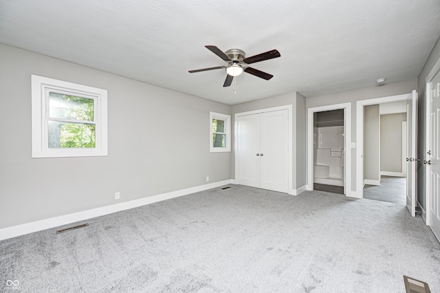 496 N County Road 325 W, Danville, IN 46122 - unfurnished bedroom with carpet floors, ceiling fan, a closet, and connected bathroom