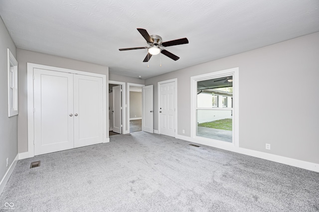496 N County Road 325 W, Danville, IN 46122 - unfurnished bedroom with carpet flooring, two closets, and a ceiling fan