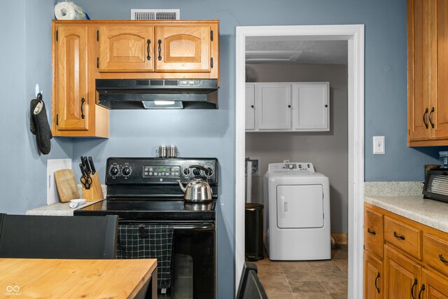 120 Hoss Rd, Indianapolis, IN 46217 - kitchen with washer / dryer, black electric range, under cabinet range hood, and butcher block countertops