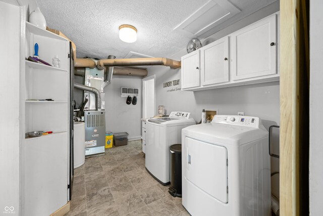 120 Hoss Rd, Indianapolis, IN 46217 - laundry area with cabinet space, washer and dryer, and a textured ceiling